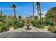 Charming backyard fountain surrounded by lush landscaping, mature trees, and ornamental foliage at 301 Lakewood Garden Dr, Las Vegas, NV 89148