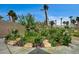 Picturesque backyard featuring beautiful flowering plants, mature palms, and manicured landscaping at 301 Lakewood Garden Dr, Las Vegas, NV 89148