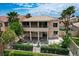 Charming two-story home featuring a tranquil backyard with a fountain and lush landscaping at 301 Lakewood Garden Dr, Las Vegas, NV 89148
