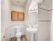 Cozy bathroom featuring a pedestal sink, toilet, and tiled shower area at 301 Lakewood Garden Dr, Las Vegas, NV 89148