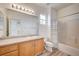 Well-lit bathroom with tile flooring, granite countertops, tub with shower, and a large mirror with vanity lighting at 301 Lakewood Garden Dr, Las Vegas, NV 89148