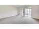 Open and spacious bedroom with sliding doors and carpeted floors at 301 Lakewood Garden Dr, Las Vegas, NV 89148
