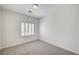 A bedroom with a window and neutral carpet, offering natural light and a simple, comfortable space at 301 Lakewood Garden Dr, Las Vegas, NV 89148