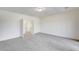 Large bedroom with carpeted floors and doors leading to the hallway at 301 Lakewood Garden Dr, Las Vegas, NV 89148