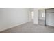 Bright bedroom with neutral carpet, closet with mirror sliding doors, and an open doorway to the hallway at 301 Lakewood Garden Dr, Las Vegas, NV 89148