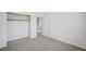 Neutral bedroom with a walk-in closet and open door, providing a functional space at 301 Lakewood Garden Dr, Las Vegas, NV 89148
