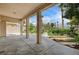Inviting covered patio with decorative concrete, substantial columns, and a view of the meticulously landscaped backyard at 301 Lakewood Garden Dr, Las Vegas, NV 89148