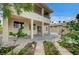 Back exterior of home featuring manicured garden, patio, balcony, and neutral color palette under a bright blue sky at 301 Lakewood Garden Dr, Las Vegas, NV 89148