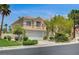 Two-story home showcasing desert landscaping, a well-maintained lawn and a two-car garage at 301 Lakewood Garden Dr, Las Vegas, NV 89148