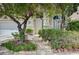Front entrance with stone steps, lush landscaping, and charming front door at 301 Lakewood Garden Dr, Las Vegas, NV 89148