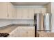 Bright kitchen features granite countertops, stainless steel fridge, and white cabinetry at 301 Lakewood Garden Dr, Las Vegas, NV 89148