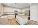 Spacious kitchen with stainless steel appliances, white cabinets, granite countertops, and a large island at 301 Lakewood Garden Dr, Las Vegas, NV 89148
