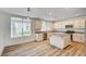 Updated kitchen features granite countertops, stainless steel appliances, an island, and hardwood floors at 301 Lakewood Garden Dr, Las Vegas, NV 89148