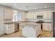Well-lit kitchen includes granite countertops, stainless steel appliances, and center island at 301 Lakewood Garden Dr, Las Vegas, NV 89148