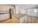 Spacious kitchen with hardwood floors, granite countertops, stainless steel appliances, and an island at 301 Lakewood Garden Dr, Las Vegas, NV 89148