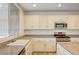 Bright kitchen features white cabinets, granite countertops, stainless steel appliances, and an island at 301 Lakewood Garden Dr, Las Vegas, NV 89148