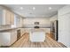 Bright kitchen features stainless steel appliances, granite countertops, an island, and hardwood floors at 301 Lakewood Garden Dr, Las Vegas, NV 89148