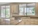 Sunlit kitchen features granite countertops, stainless dishwasher and a view of palms and mountains at 301 Lakewood Garden Dr, Las Vegas, NV 89148