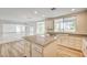 Bright kitchen featuring granite countertops, white cabinets and stainless steel dishwasher overlooking backyard at 301 Lakewood Garden Dr, Las Vegas, NV 89148