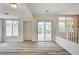 Bright living room features wood-look floors, recessed lighting, and views of the backyard at 301 Lakewood Garden Dr, Las Vegas, NV 89148
