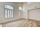 Bright living room featuring wood-style floors and large windows at 301 Lakewood Garden Dr, Las Vegas, NV 89148