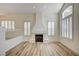 Bright living room featuring wood-style floors, fireplace and shuttered windows at 301 Lakewood Garden Dr, Las Vegas, NV 89148