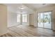 Light-filled living room boasts wood-look floors, with views of palms and outdoor water feature at 301 Lakewood Garden Dr, Las Vegas, NV 89148