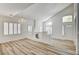 Living room showcasing wood-style floors, fireplace, and bright windows at 301 Lakewood Garden Dr, Las Vegas, NV 89148