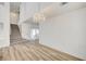 Open-concept living room with wood-style floors, staircase, and chandelier at 301 Lakewood Garden Dr, Las Vegas, NV 89148