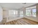 Spacious living room features hardwood floors, large windows with neighborhood views, and bright neutral paint at 301 Lakewood Garden Dr, Las Vegas, NV 89148