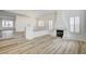 Bright living room featuring wood-style floors, fireplace and shuttered windows at 301 Lakewood Garden Dr, Las Vegas, NV 89148