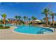 Sparkling swimming pool surrounded by palm trees, lounge chairs, and inviting umbrellas for shade and relaxation at 301 Lakewood Garden Dr, Las Vegas, NV 89148