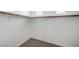 Spacious walk-in closet with carpet floors and wooden clothing rods at 301 Lakewood Garden Dr, Las Vegas, NV 89148