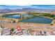 An aerial view showing a home in a location with access to walking paths and several lakes and ponds at 330 Spring Dove Ave, Henderson, NV 89011