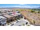A bird's eye view of a community with well-maintained homes and a winding road. Mountains are in the distance at 330 Spring Dove Ave, Henderson, NV 89011