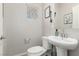 Powder room with a pedestal sink and toilet at 330 Spring Dove Ave, Henderson, NV 89011
