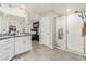 Bathroom featuring double sinks, granite countertops, and a glass-enclosed shower with a showerhead at 330 Spring Dove Ave, Henderson, NV 89011