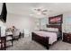 Cozy bedroom featuring a dark wood bed frame, a desk, and ample natural light from the windows at 330 Spring Dove Ave, Henderson, NV 89011