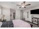 Bright bedroom with a ceiling fan, carpeted floors, and a view into the ensuite bathroom at 330 Spring Dove Ave, Henderson, NV 89011