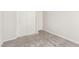 Empty bedroom with gray carpet, white walls, closet and access to another room at 330 Spring Dove Ave, Henderson, NV 89011