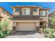 Two-story home with a neutral color scheme, a two car garage, and manicured landscaping at 330 Spring Dove Ave, Henderson, NV 89011
