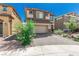 Charming two-story home with an attached garage and a well maintained front yard at 330 Spring Dove Ave, Henderson, NV 89011