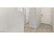 Bright hallway with tile flooring and white doors leading to various rooms at 330 Spring Dove Ave, Henderson, NV 89011