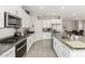 Kitchen with stainless steel appliances, granite countertops, a stainless steel sink, and white cabinetry at 330 Spring Dove Ave, Henderson, NV 89011