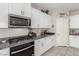 Close up of a kitchen featuring stainless steel appliances, granite counters, and white upper and lower cabinets at 330 Spring Dove Ave, Henderson, NV 89011