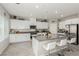 Bright kitchen with white cabinets, stainless steel appliances, granite countertops, and barstool seating at 330 Spring Dove Ave, Henderson, NV 89011
