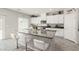 Kitchen island featuring granite countertops, a built-in sink, a microwave, and white cabinets at 330 Spring Dove Ave, Henderson, NV 89011