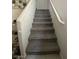 Carpeted staircase featuring a white railing and leading to the upper level of the home at 330 Spring Dove Ave, Henderson, NV 89011