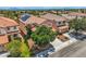 Aerial view of a two-story home with solar panels, a red tile roof, mature trees, and a two-car garage at 3412 Crystal Tower St, Las Vegas, NV 89129