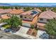 Aerial view of a two-story home with solar panels, a red tile roof, mature trees, and a two-car garage at 3412 Crystal Tower St, Las Vegas, NV 89129